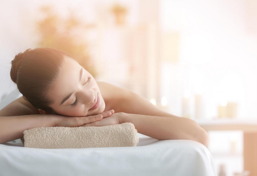 woman laying on spa bed